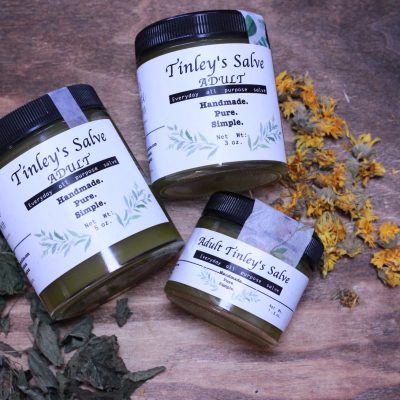 3 jars of Tinley's salve laying with label facing up